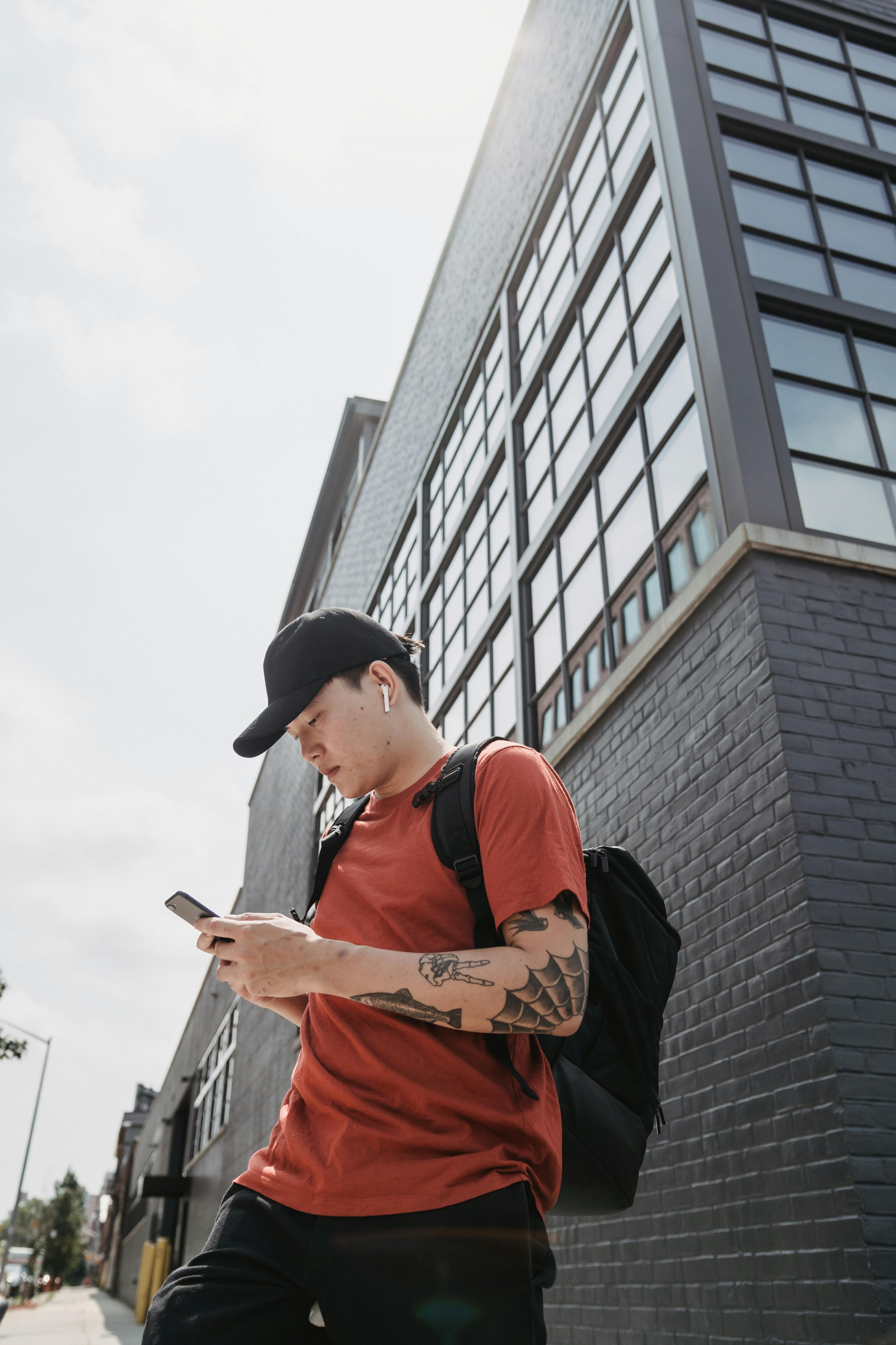 Person using mobile phone with Hypear custom in-ear monitors for everyday music listening and phone calls - custom-fit earbuds that stay secure during daily activities and provide superior sound quality