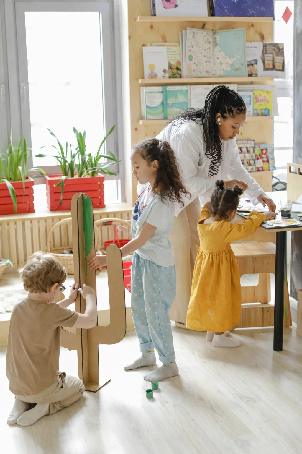 Preschool teacher wearing Hypear custom in-ear monitors for hearing protection in educational environments - protecting hearing from constant noise while maintaining ability to hear children and communicate clearly