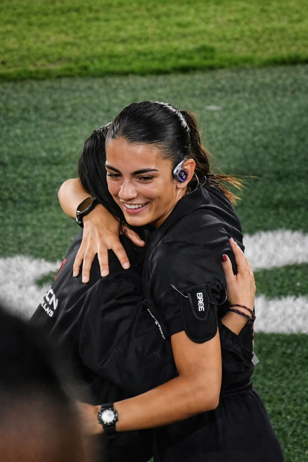 Sports referee wearing Hypear custom in-ear monitors for hearing protection during games - protecting hearing from crowd noise and game sounds while maintaining ability to hear important audio cues